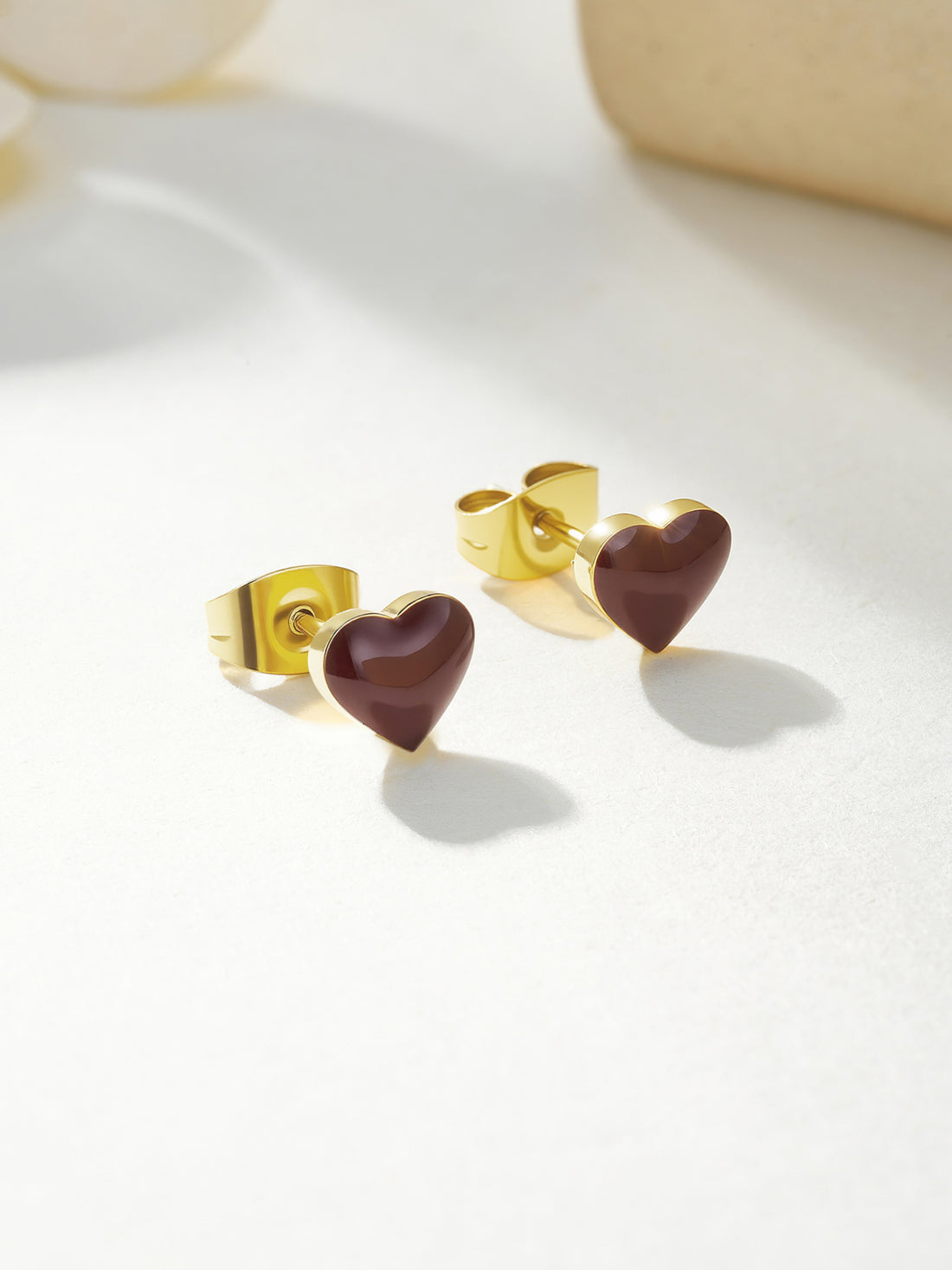 Heart-shaped earrings with gold rims on a white background