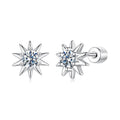 Star-shaped silver earrings with clear gemstones on a white background