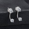 Silver earrings with clear gemstones on a black background