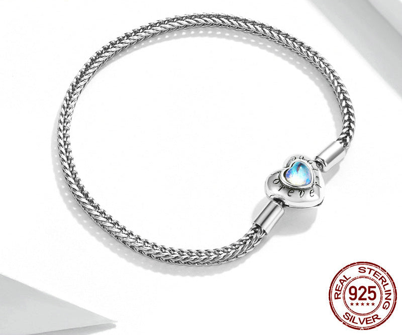 Silver bracelet with heart-shaped charm on a white background, featuring YIZIV brand logo.