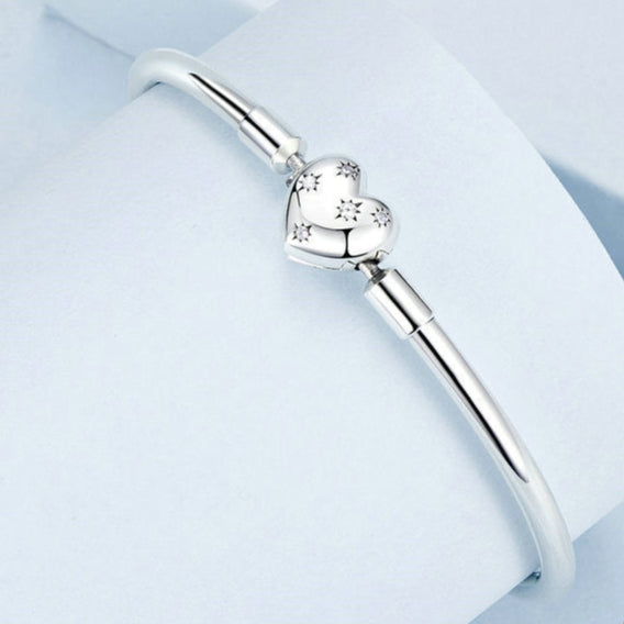 Silver bracelet with heart charm and YIZIY brand logo on a white background