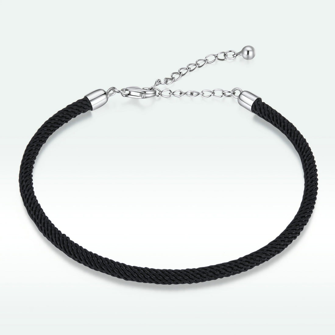 Black braided bracelet with silver clasp on a white background