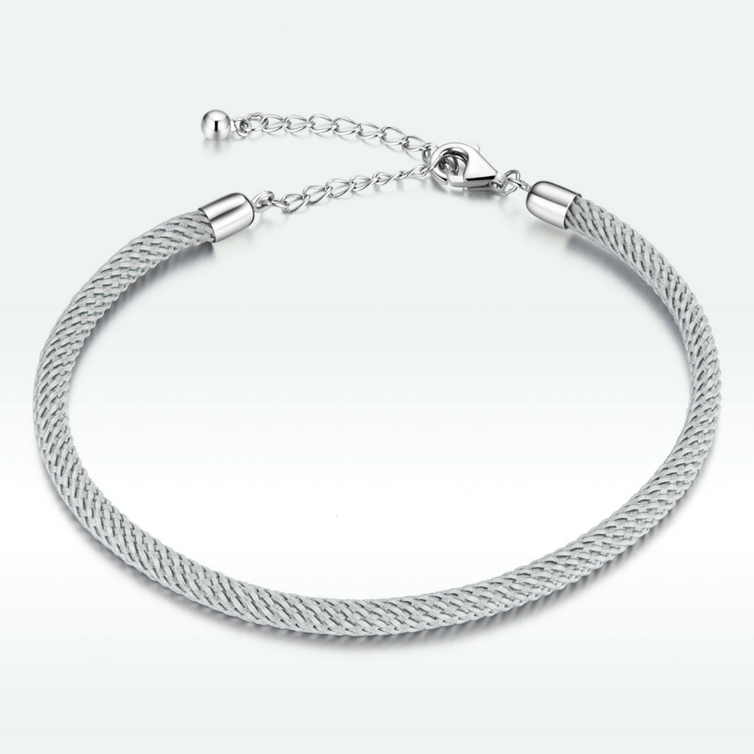 Silver bracelet with a textured band on a white background