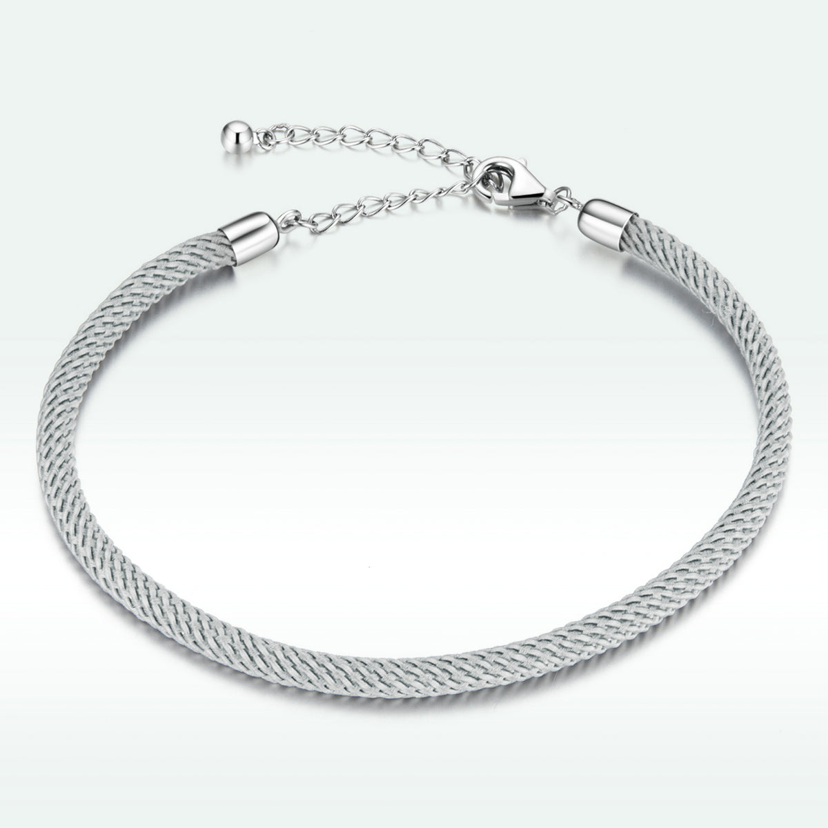Silver bracelet with a textured band on a white background