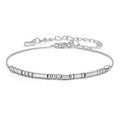 Silver bracelet with cylindrical beads on a white background