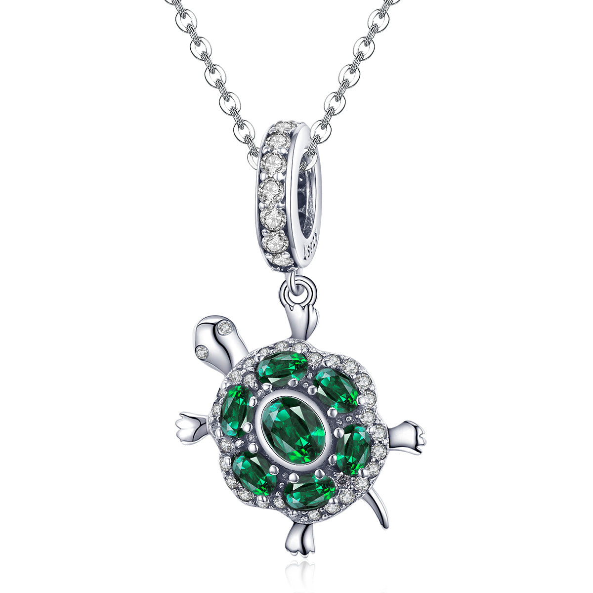 Tortoise-shaped pendant with green gemstones on a white background