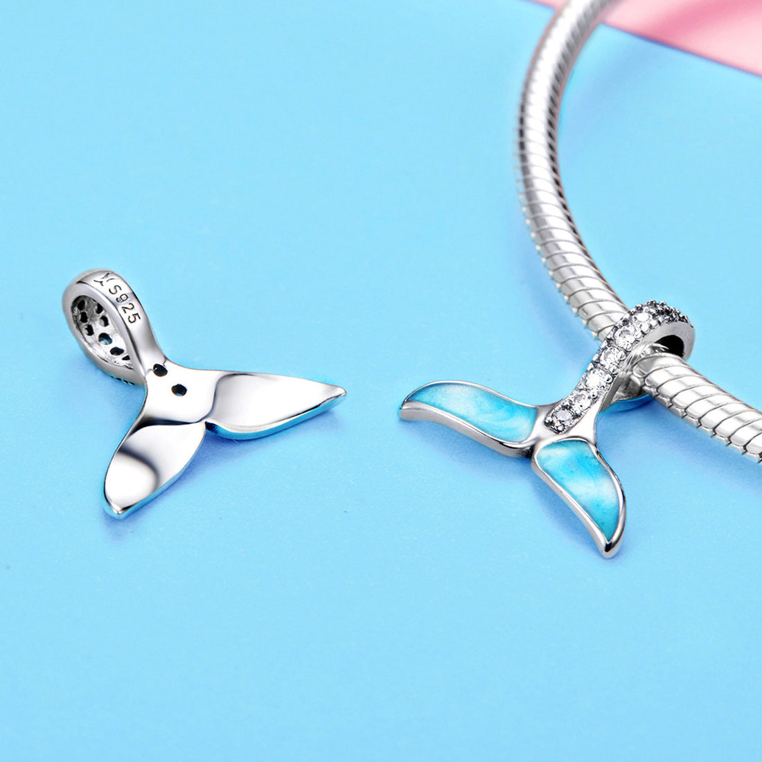 Jewelry pendant with turquoise stones and diamond accents on a white background