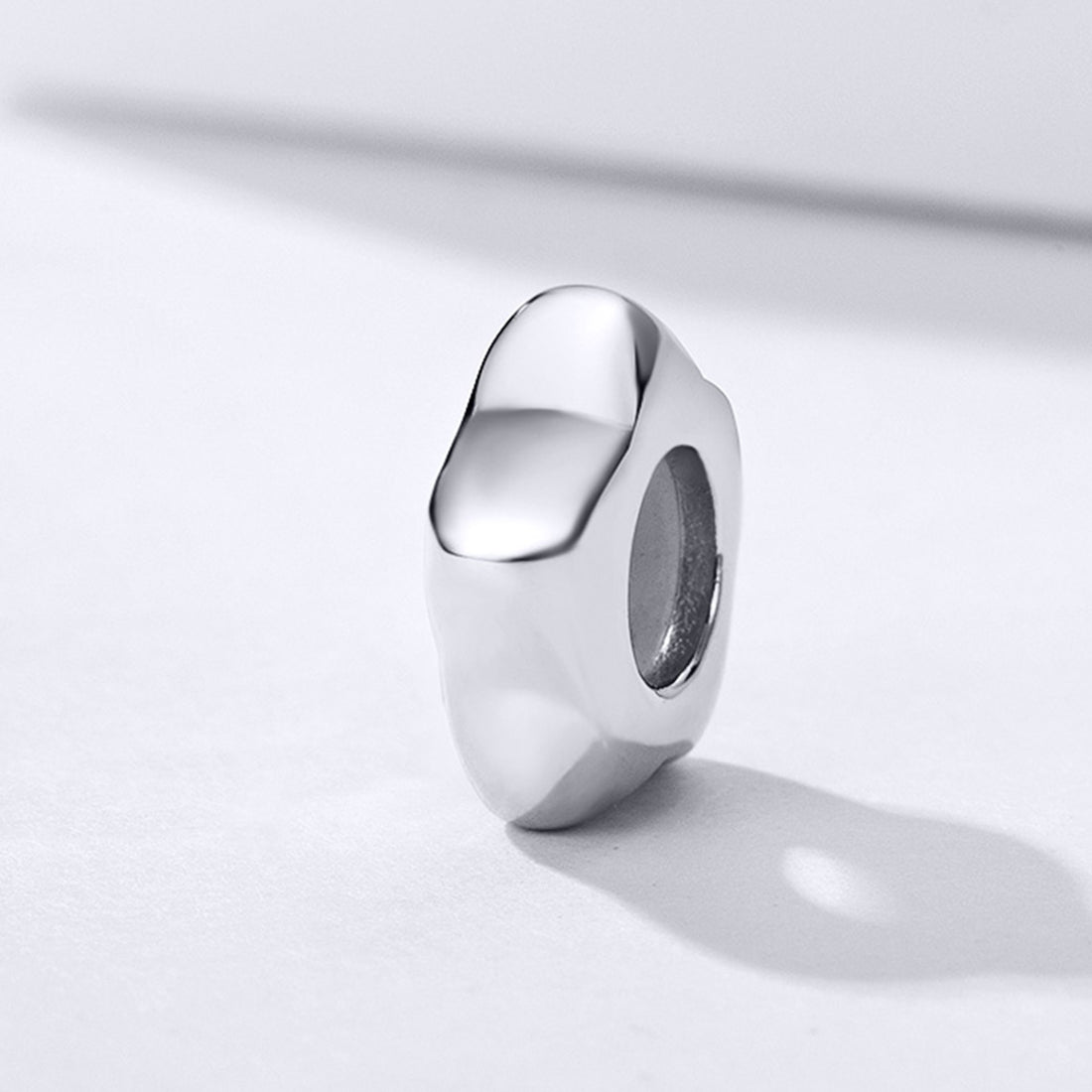 Silver ring on a light gray background