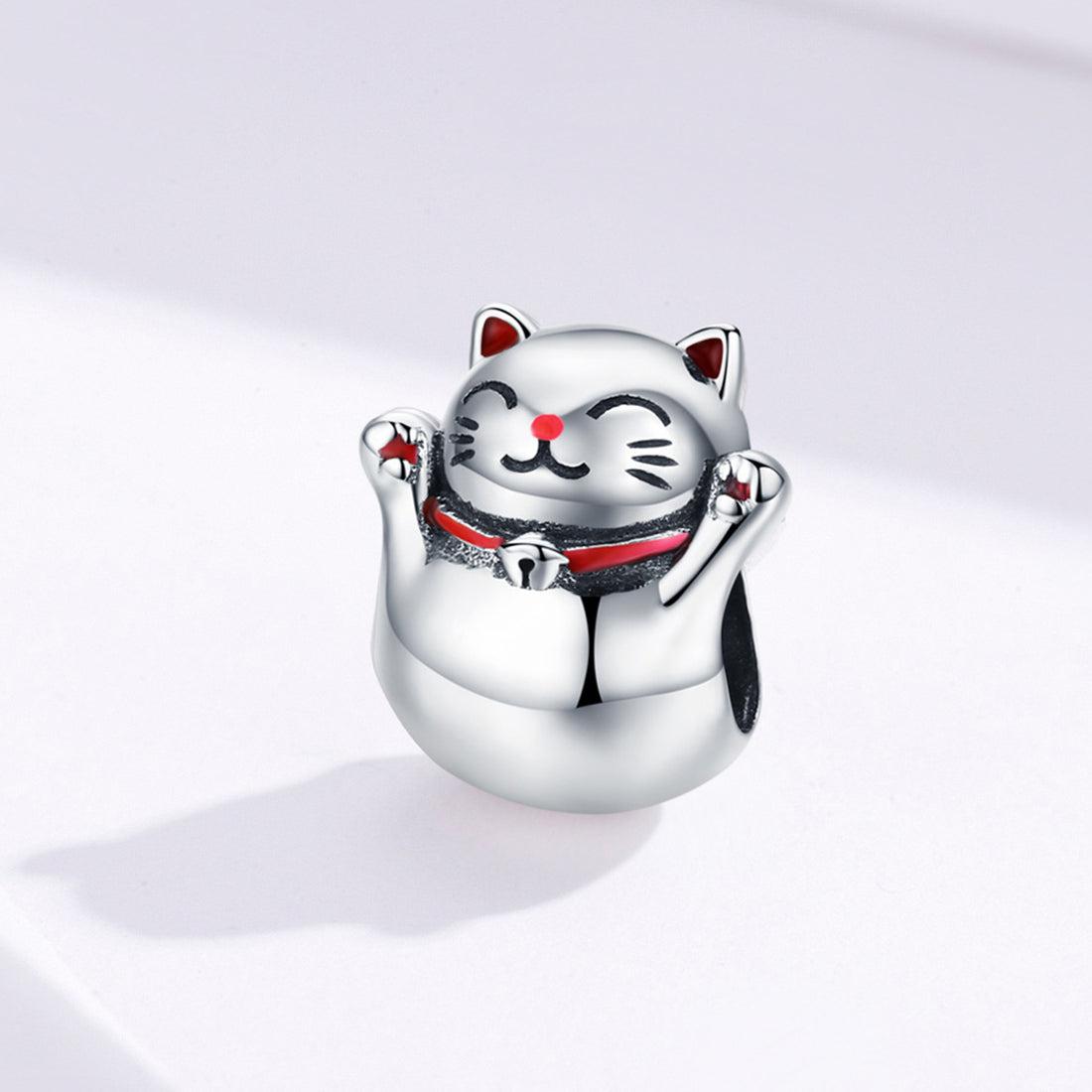 Silver cat-shaped charm on a light gray background