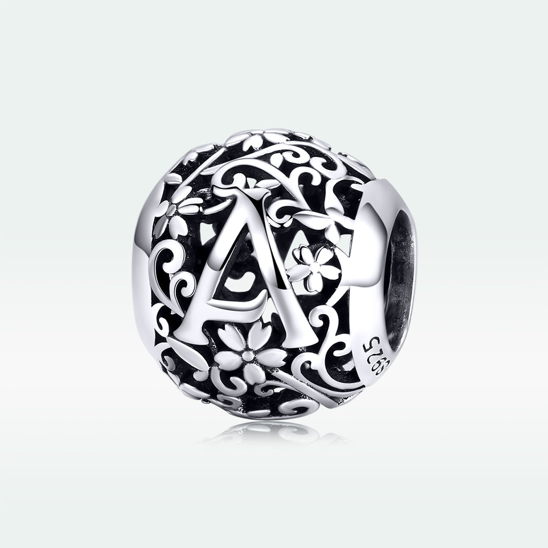 Silver charm with letter 'A' and floral designs on a white background