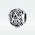 Silver charm with letter 'A' and floral designs on a white background