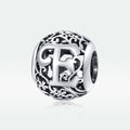 Silver charm with intricate design and letter 'E' on a white background