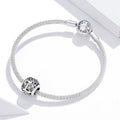 Silver bracelet with charms on a white background