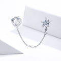 Silver earrings with starfish and shell design on a white background