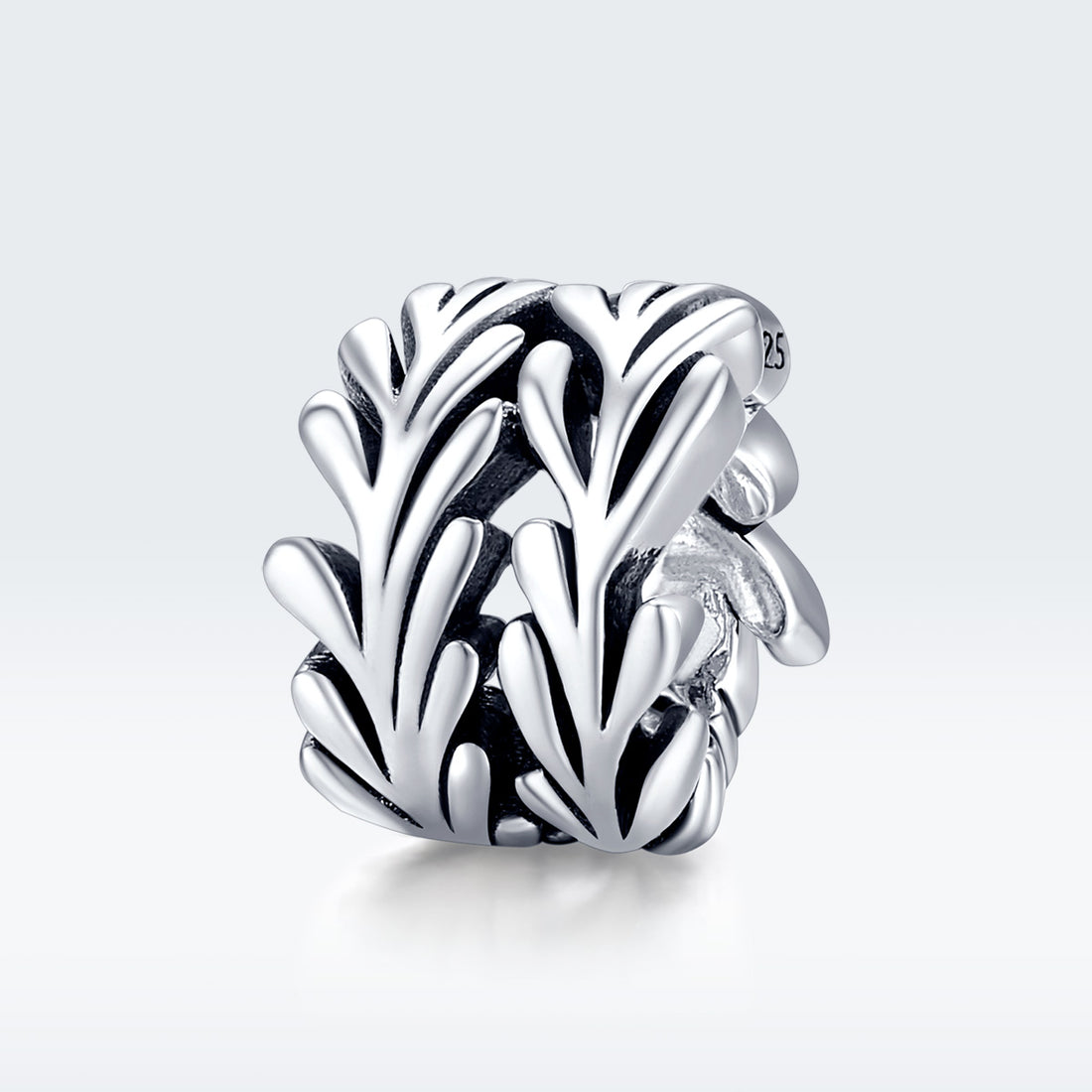 Silver leaf-shaped charm on a white background