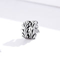 Silver leaf-shaped charm on a white background