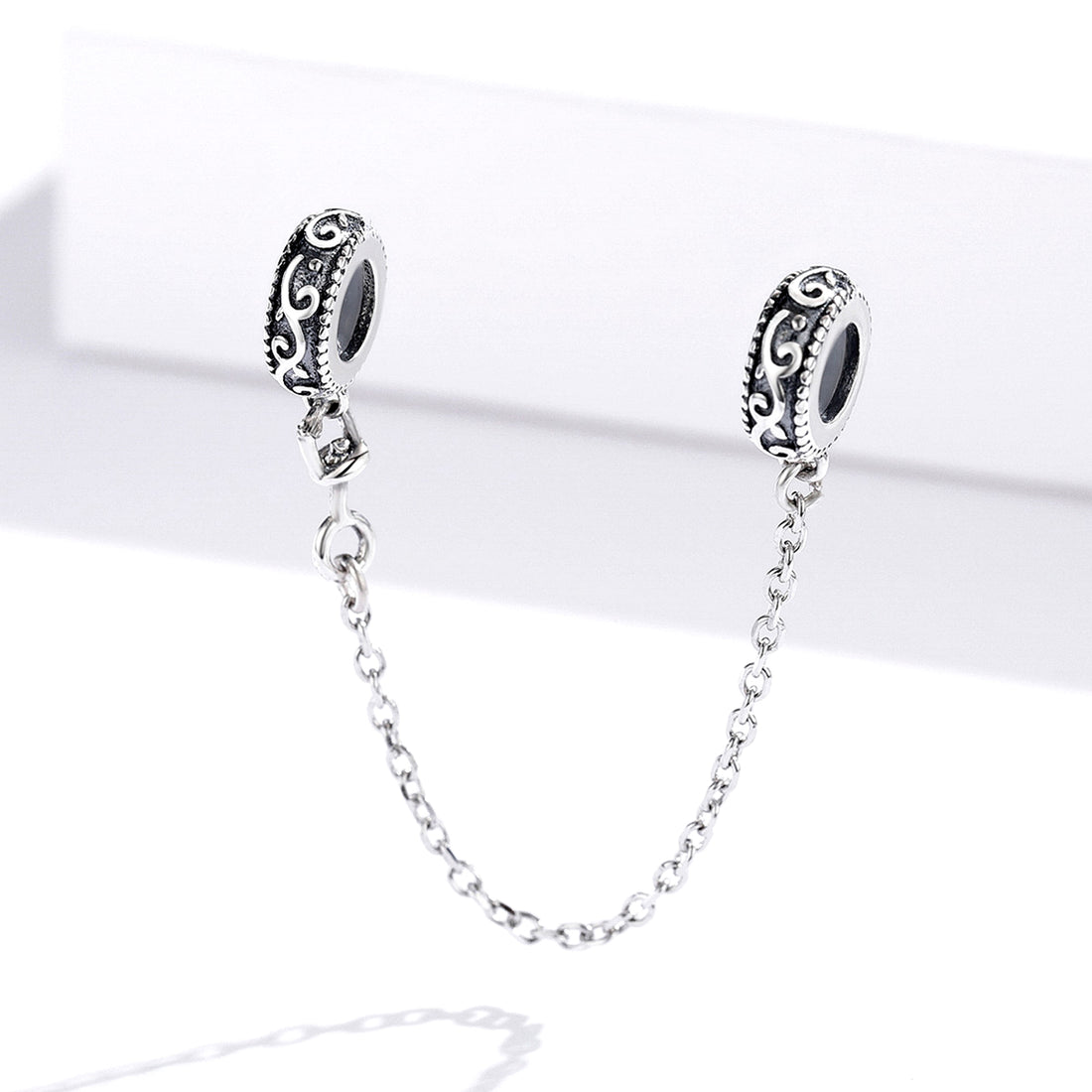 Safety chain with intricate designs on a light Gray background