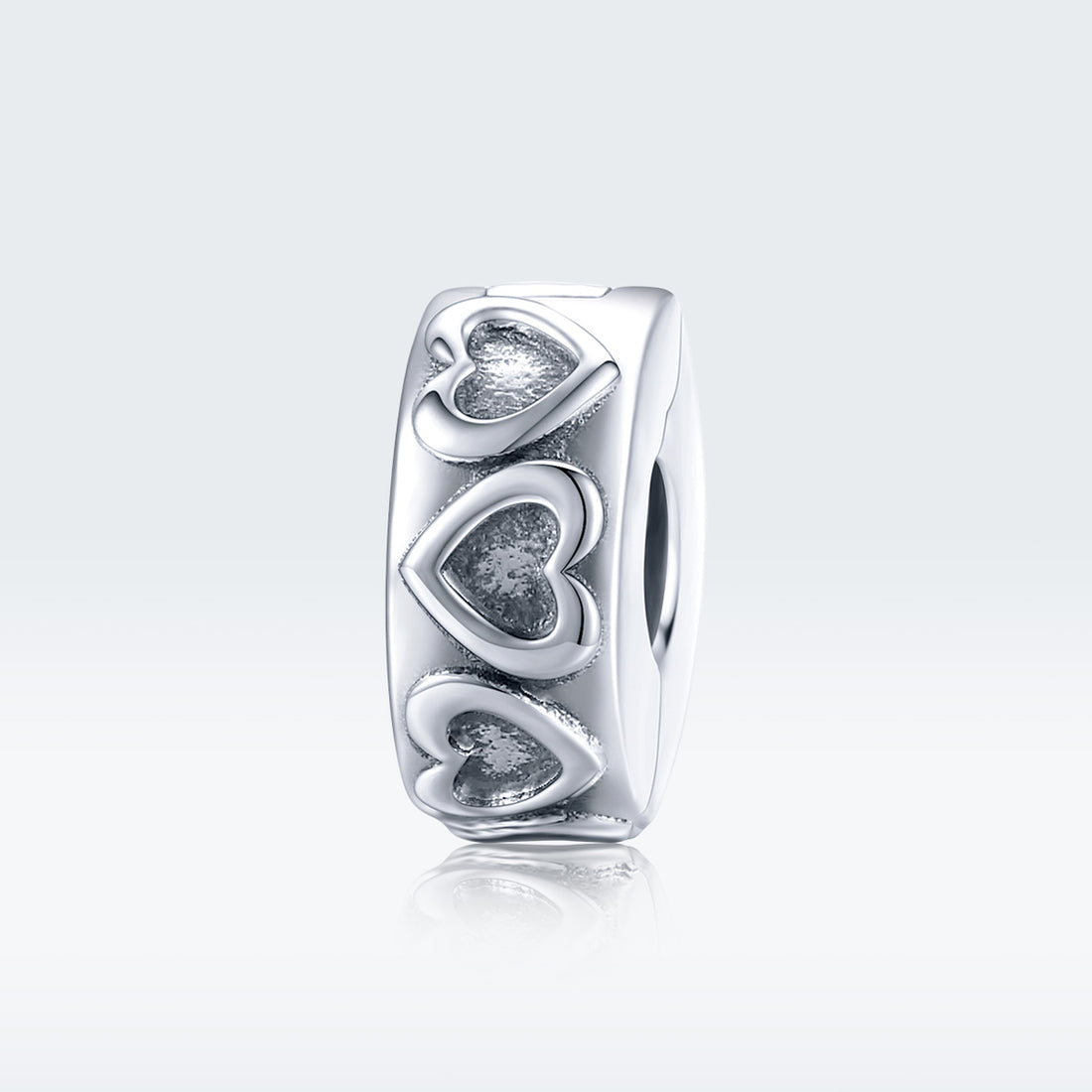 Silver ring with heart designs on a white background