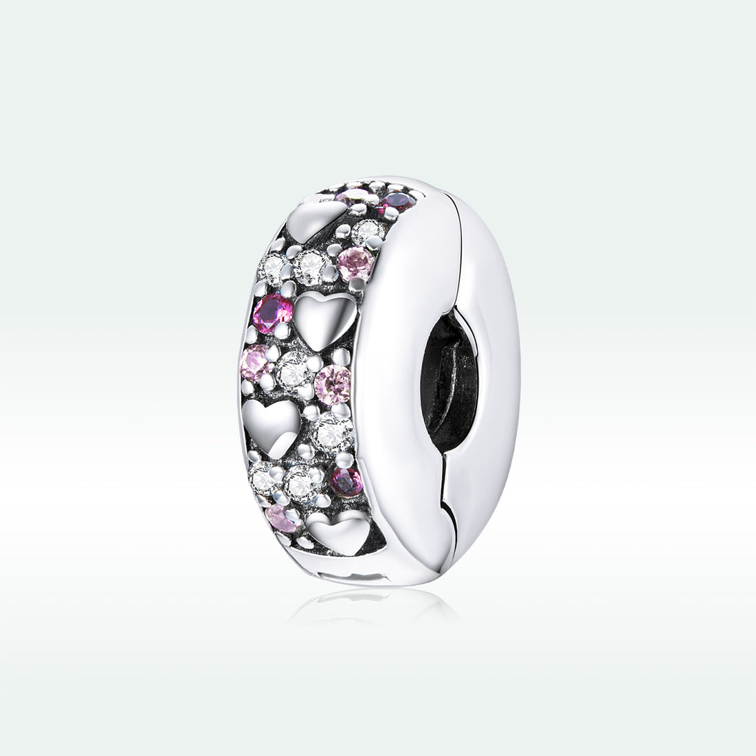 Silver charm with pink and clear stones on a light gray background