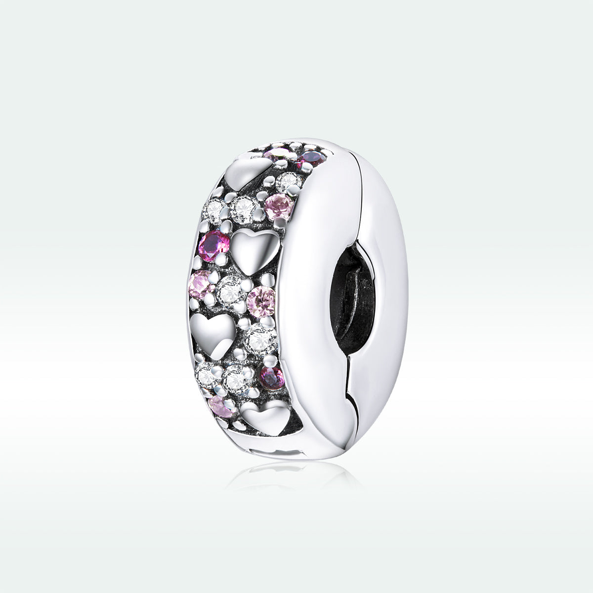 Silver charm with pink and clear stones on a light gray background