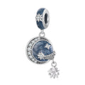 Silver charm with star and moon design on a white background