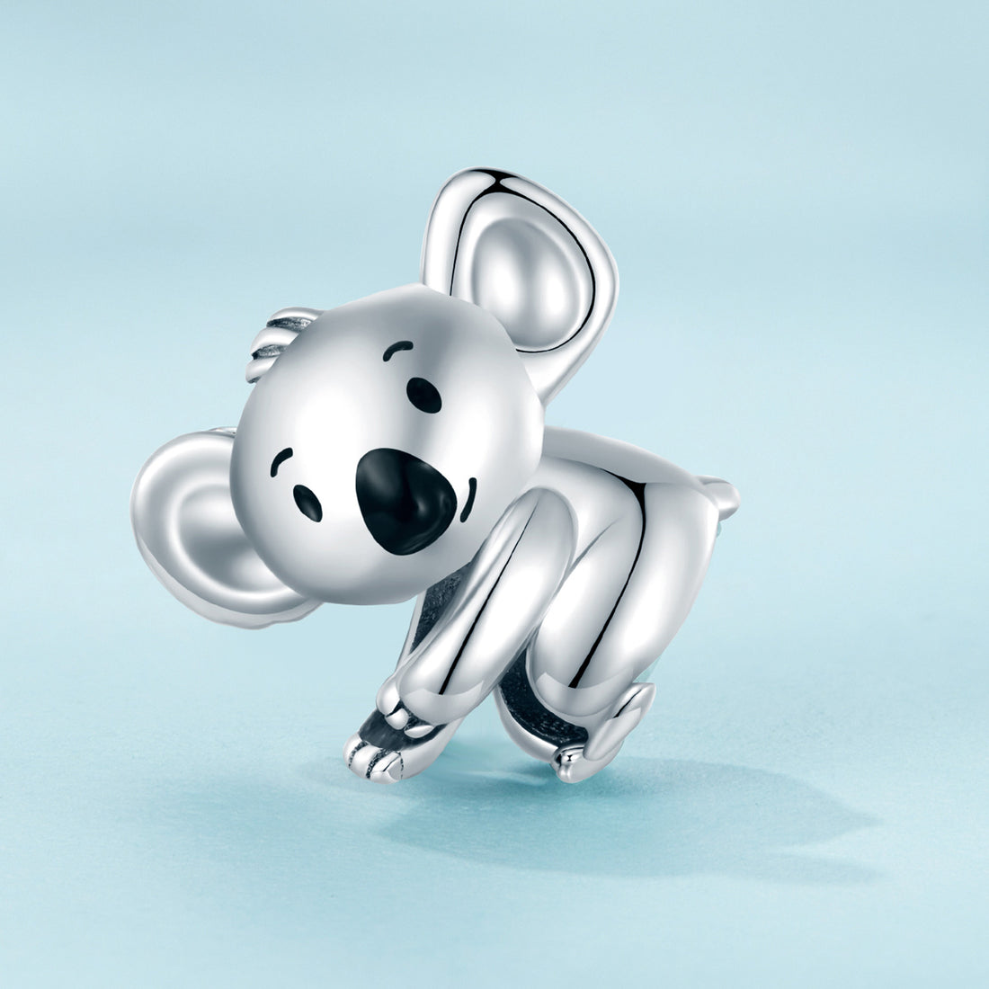 Silver koala charm on a light blue background
