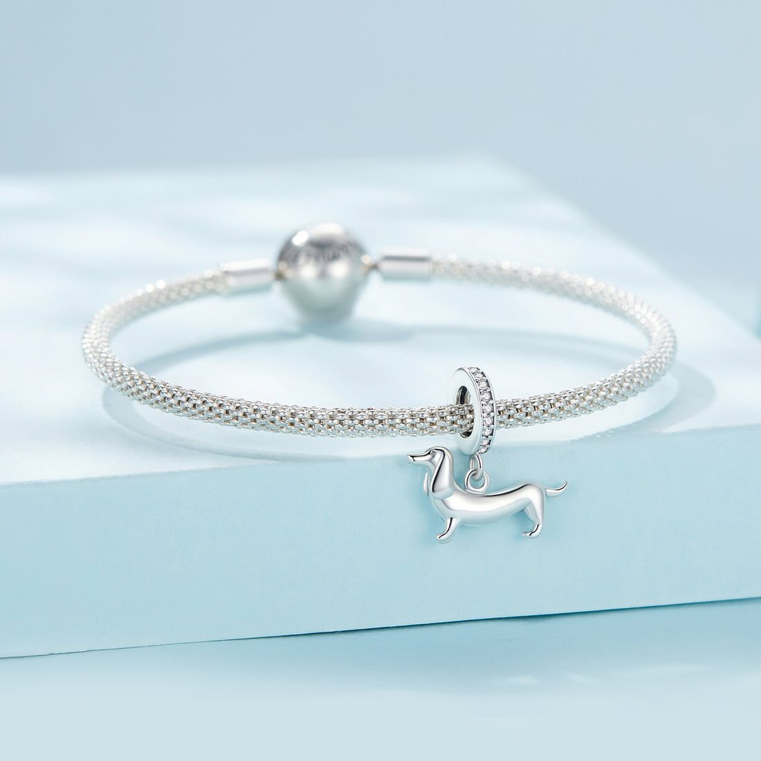 Silver dachshund dog charm with clear stones on a white background