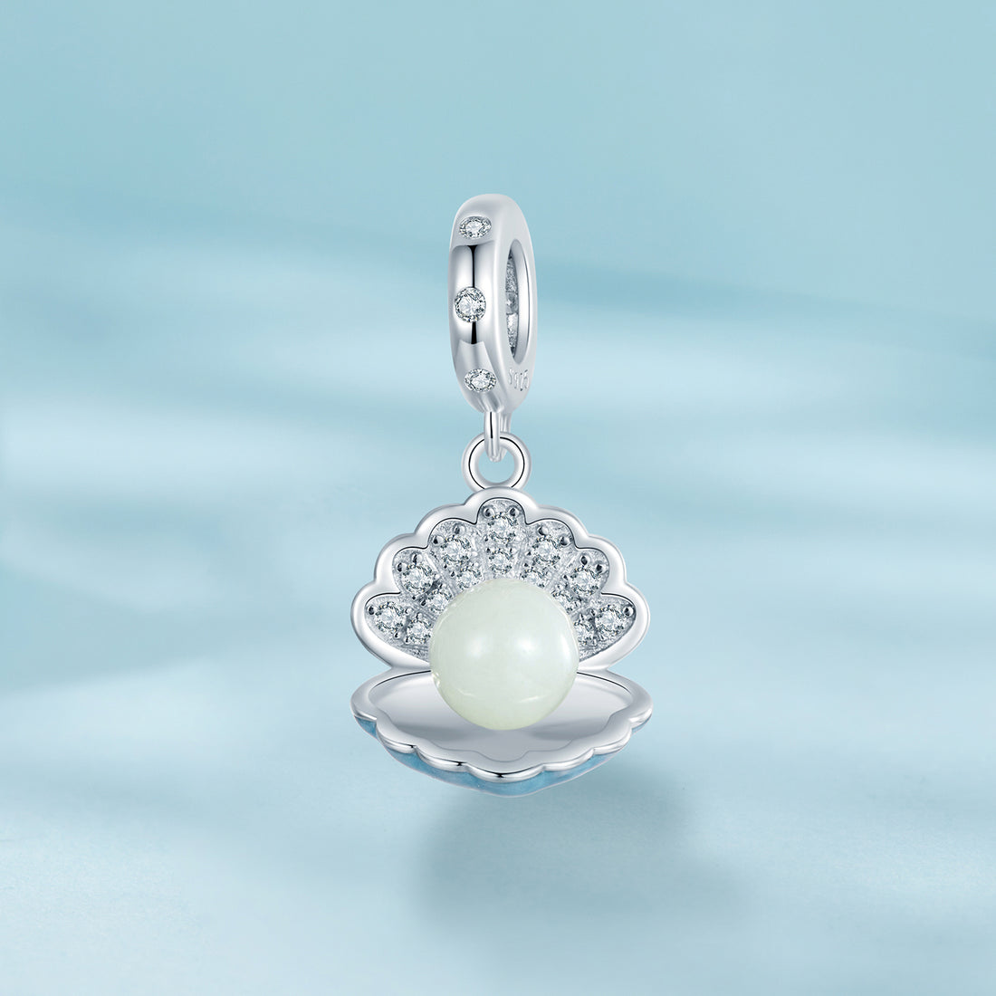 Silver pendant with a pearl on a light blue background