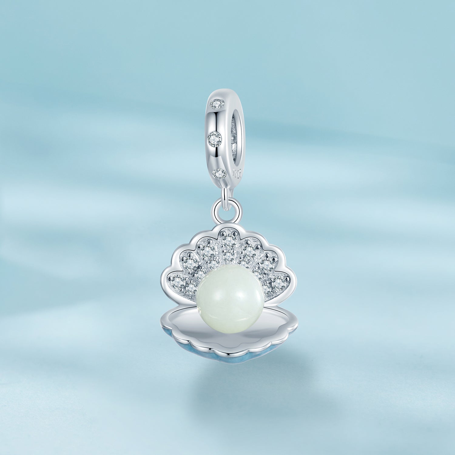 Silver pendant with a pearl on a light blue background