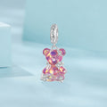 Pink teddy bear charm on a light blue background