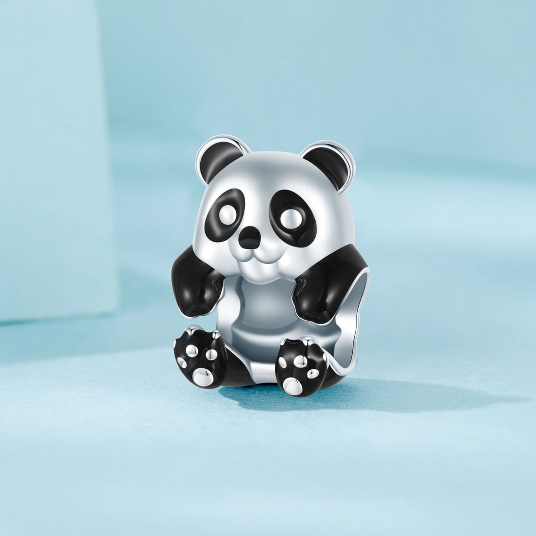 Panda-shaped silver charm on a light blue background