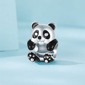 Panda-shaped silver charm on a light blue background
