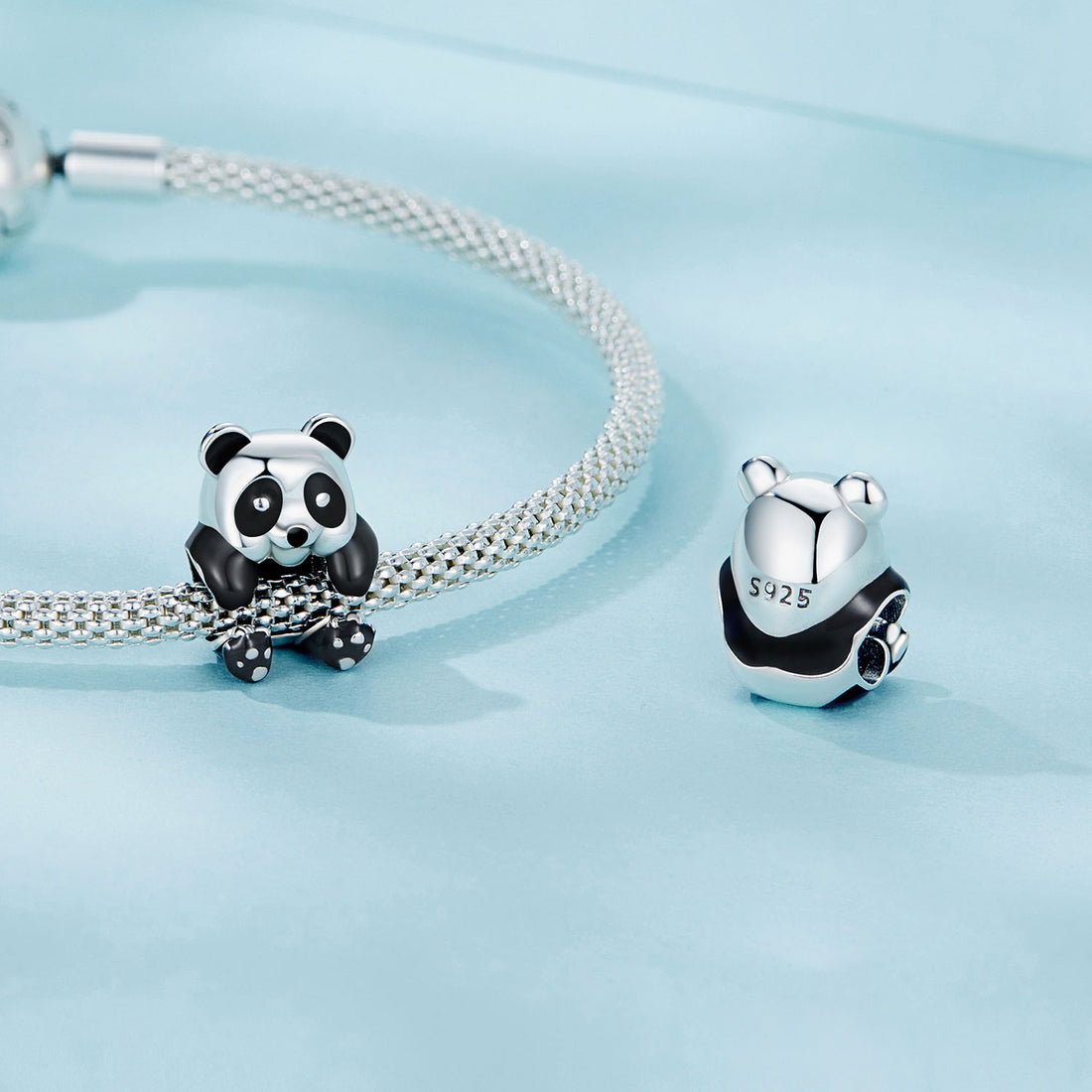 Panda-shaped silver charm on a light blue background