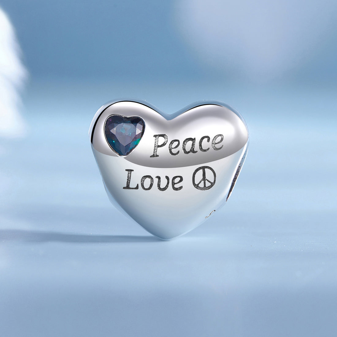 Heart-shaped charm with 'Peace Love' text and purple heart inset on a white background