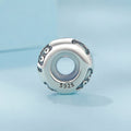 Silver charm with blue accents on a light blue background