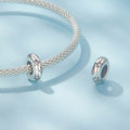 Silver bracelet with two matching charms on a light blue background