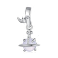 Silver charm with a white bead on a white background