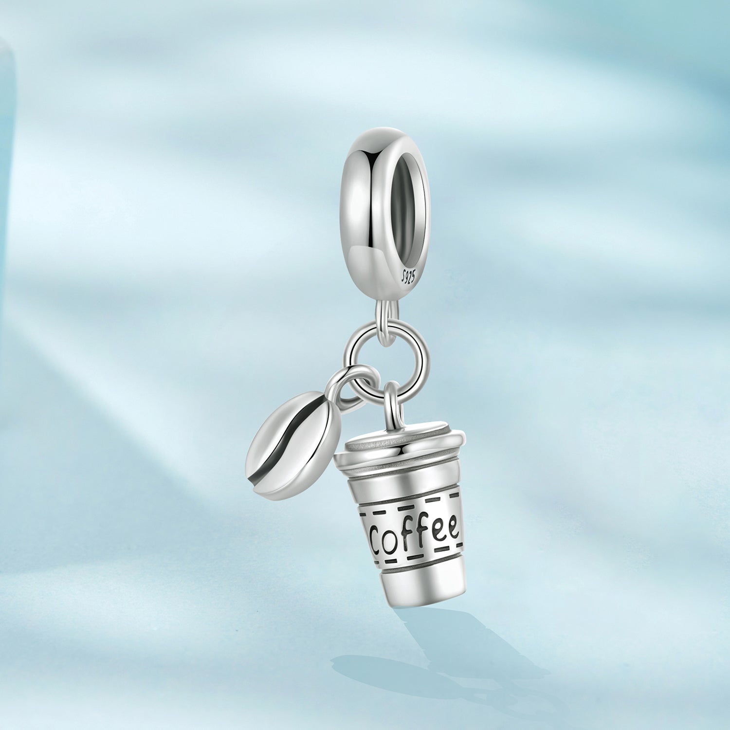 Silver charm shaped like a coffee cup with 'Coffee' text on a light blue gradient background