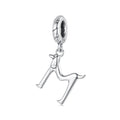 Silver charm shaped like a dog on a white background