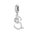Silver dog charm on a white background