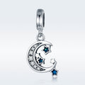Silver pendant with moon and star design on a light gray background