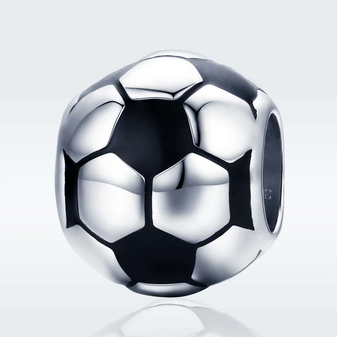 Silver soccer ball charm on a light gray background
