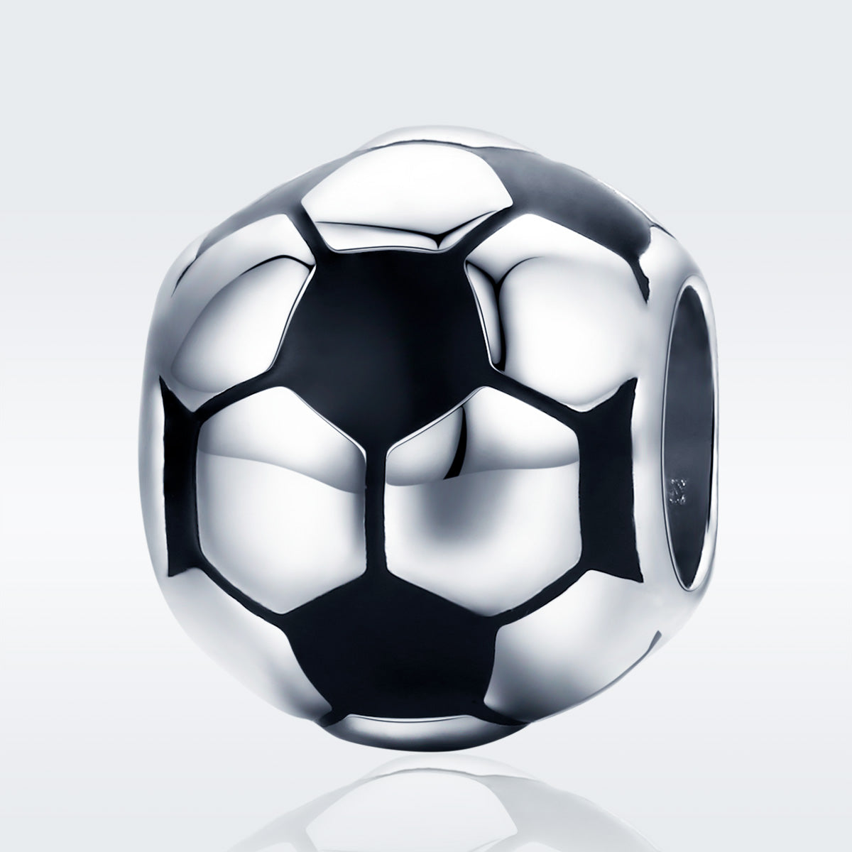 Silver soccer ball charm on a light gray background