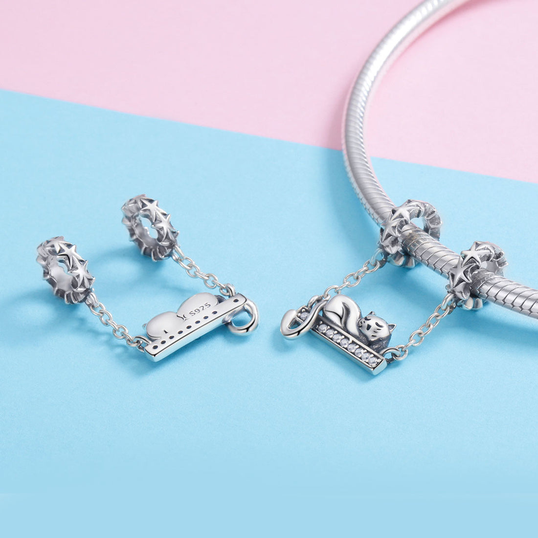 Silver cat charm on a chain with a white background