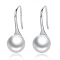 Pair of silver earrings with pearl-like spherical ends on a white background