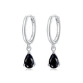 Silver hoop earrings with black teardrop gemstones on a white background