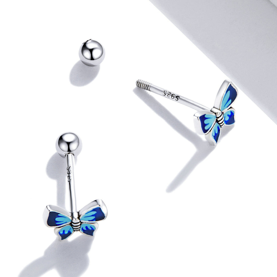 Butterfly-shaped earrings with blue wings on a white background