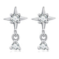 Silver earrings with star design and clear gemstones on a white background