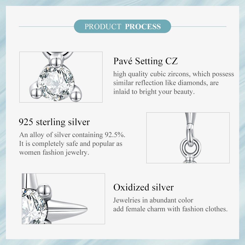 Silver earrings with star design and clear gemstones on a white background