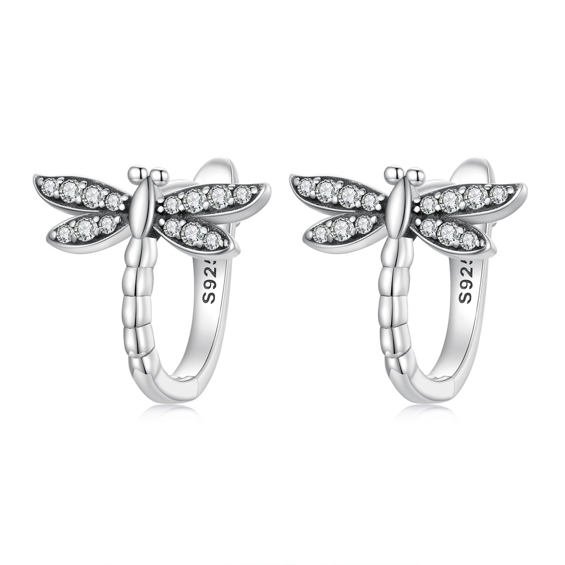 Silver dragonfly-shaped earrings with clear gemstones on a white background